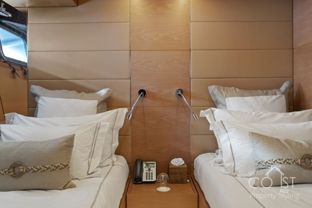 A bedroom with two beds and a phone on the nightstand.