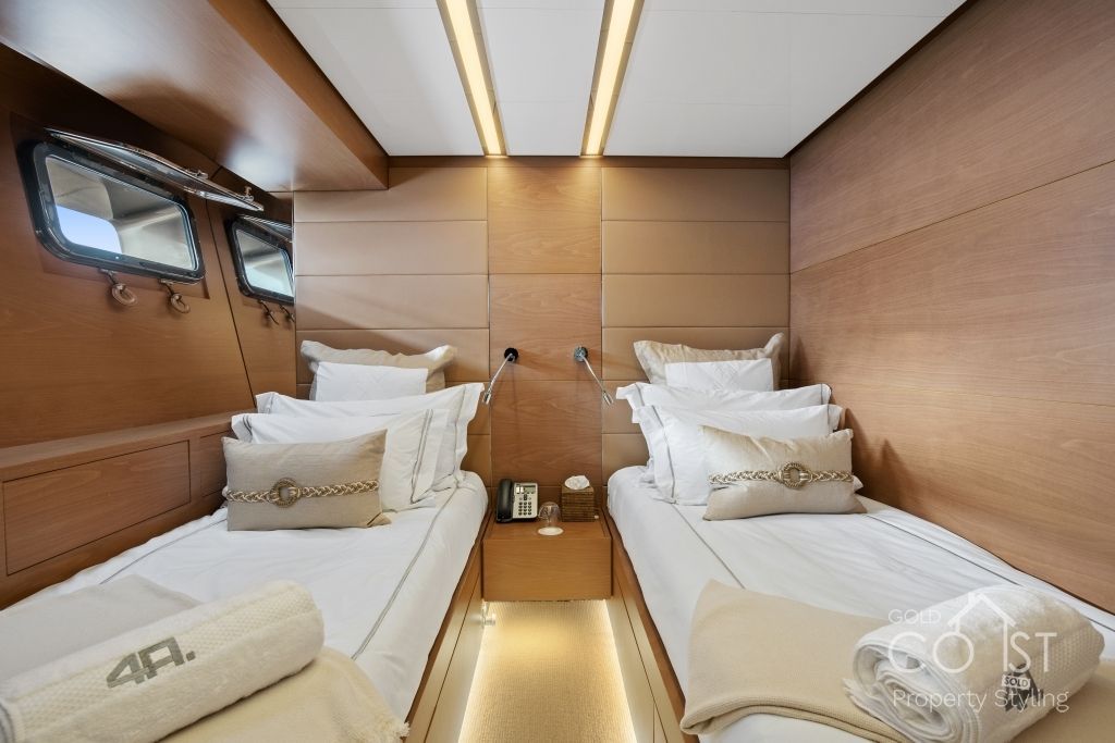 A bedroom with two beds and a towel that says 4p on it