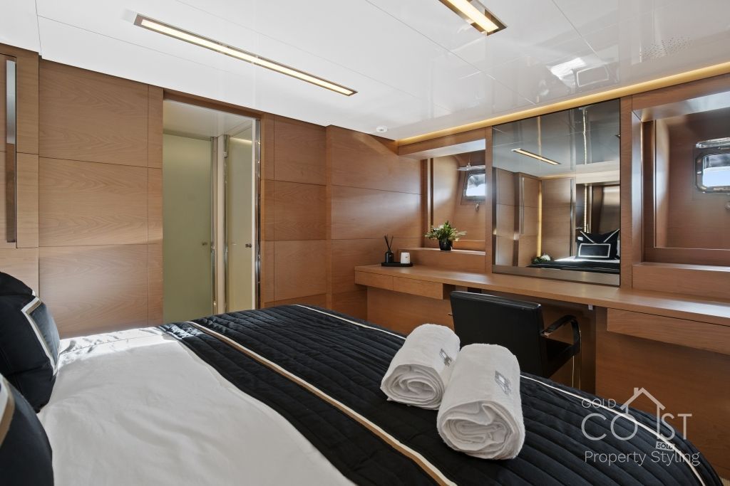 A bedroom with a large bed and two towels on the bed.