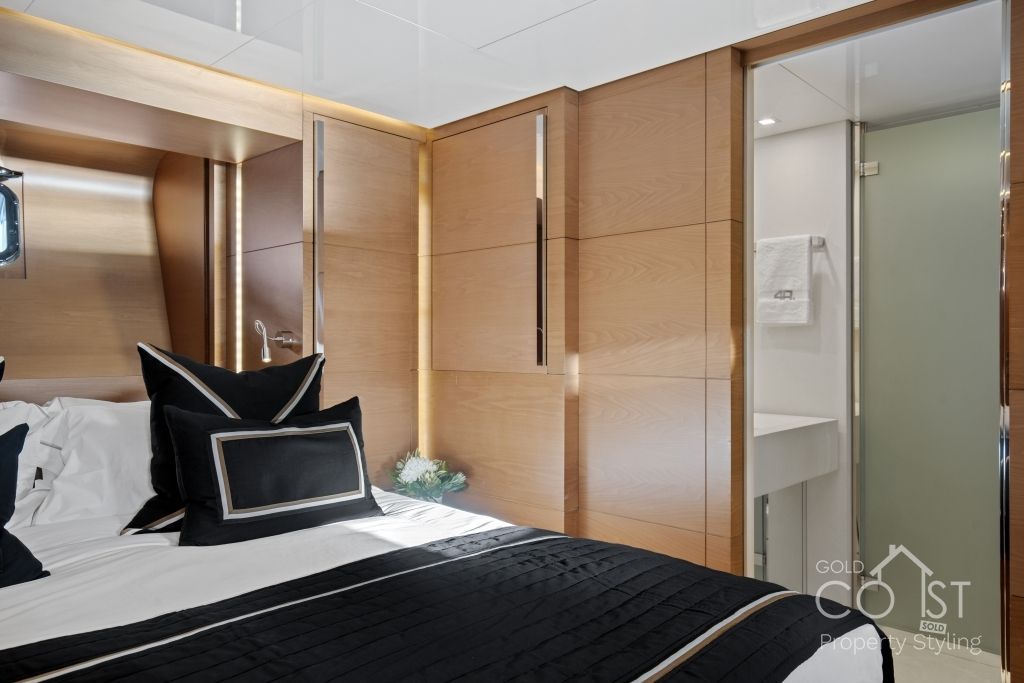 A bedroom with a large bed and a bathroom