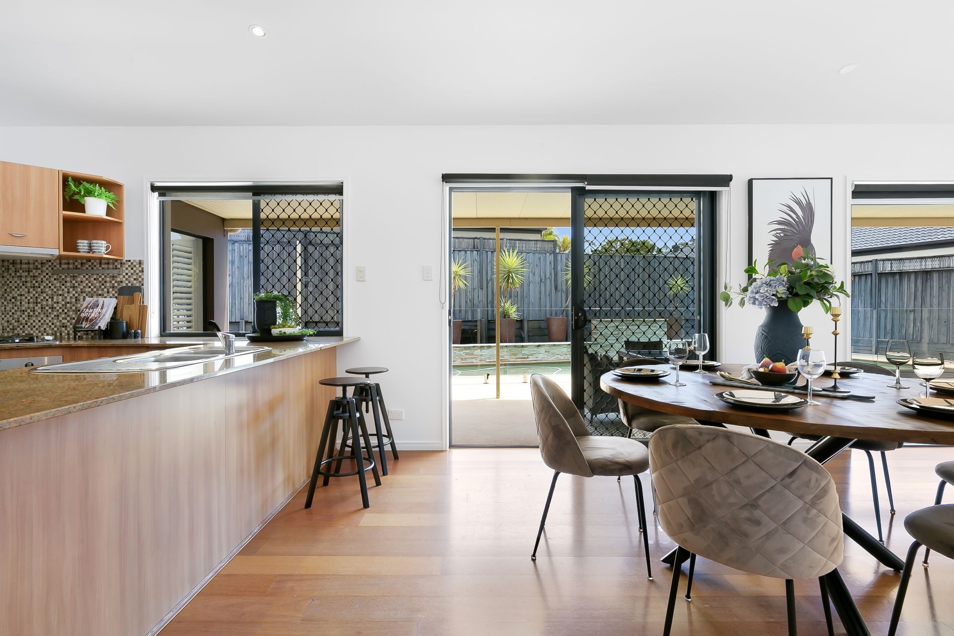 A kitchen and dining room in a house with a table and chairs.
