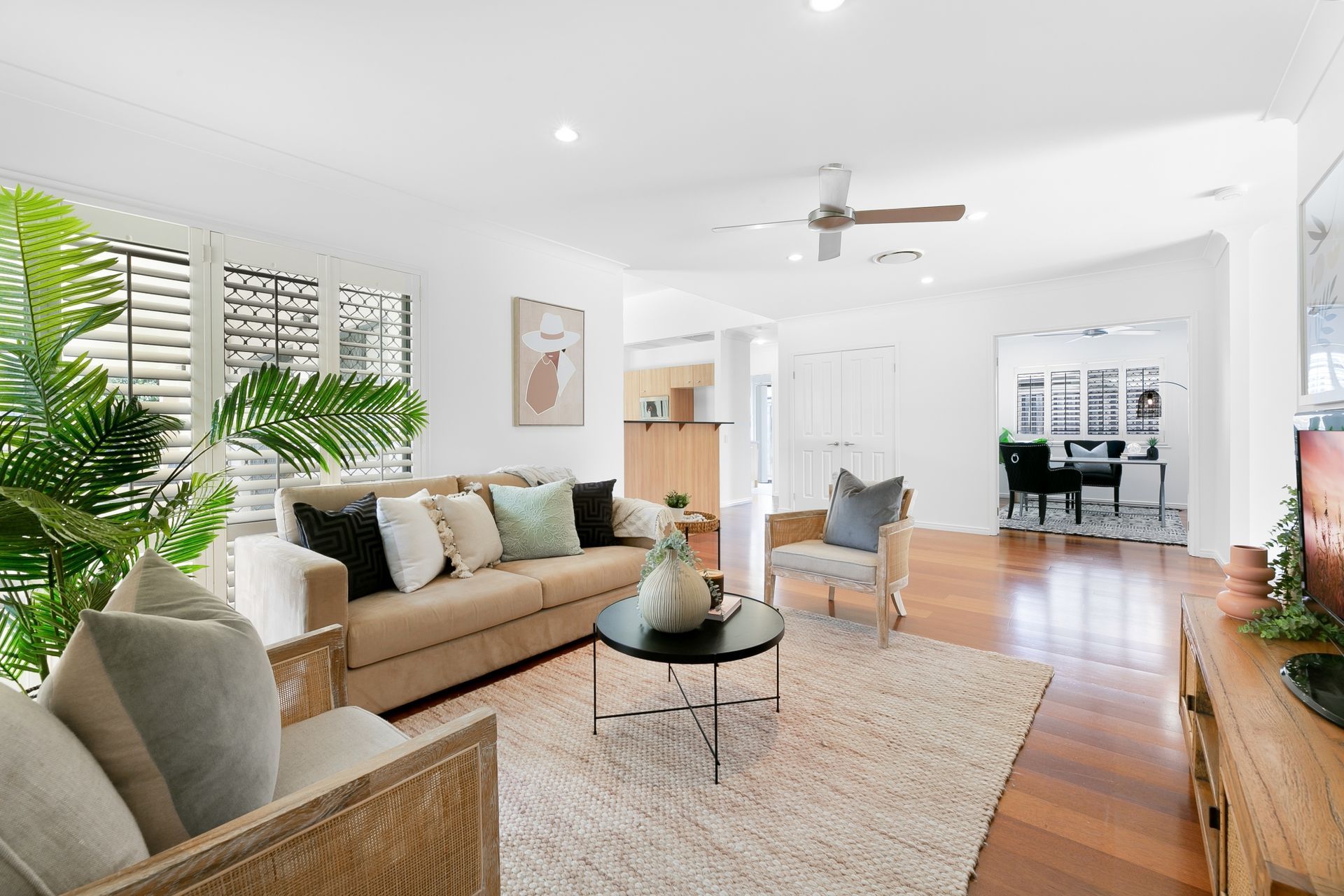 A living room filled with furniture and a ceiling fan.