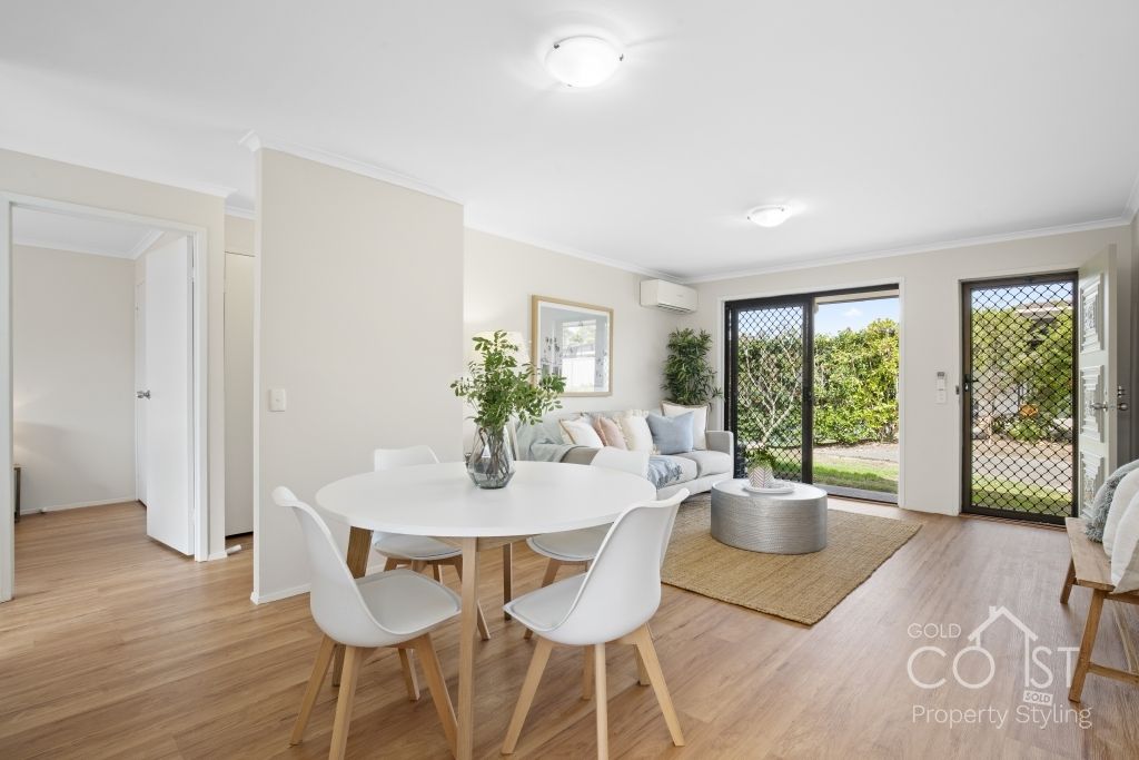 A living room with a table and chairs and a couch.