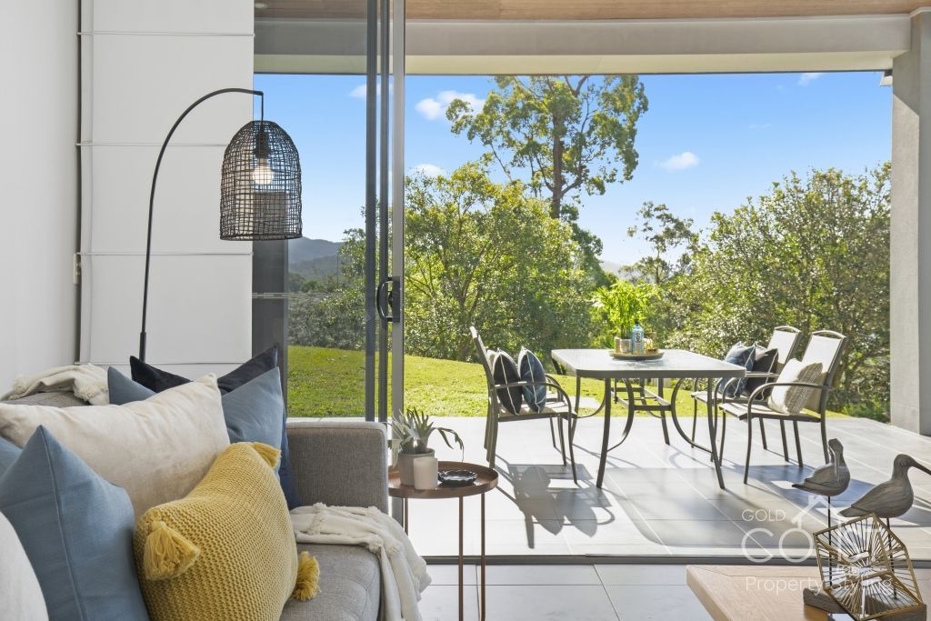 A living room with a couch and a table and chairs