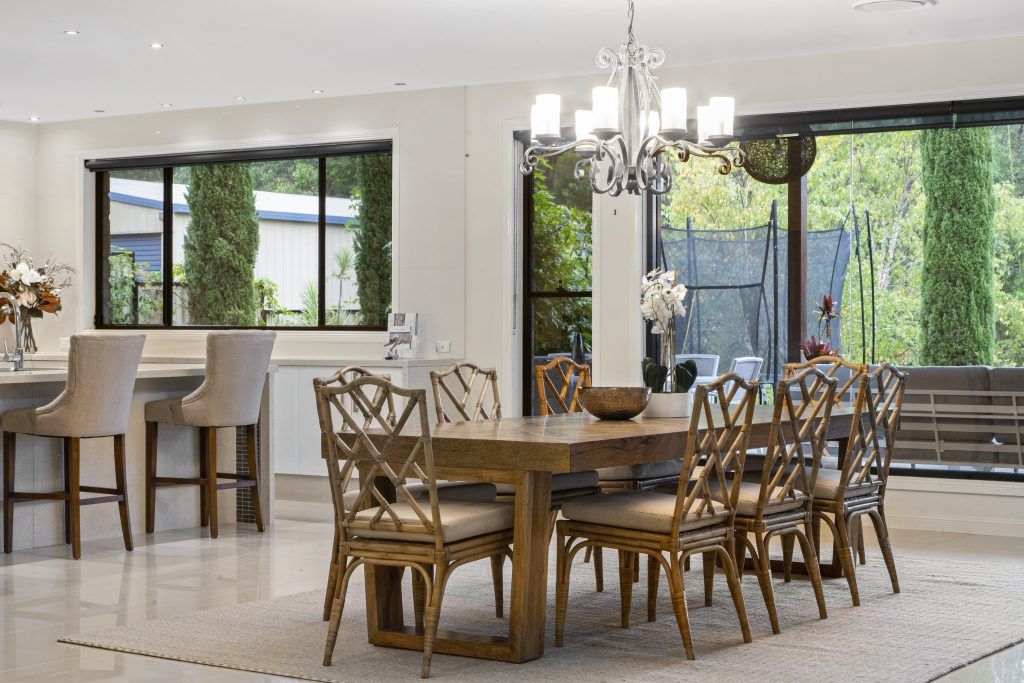 A large dining room with a table and chairs and a chandelier.