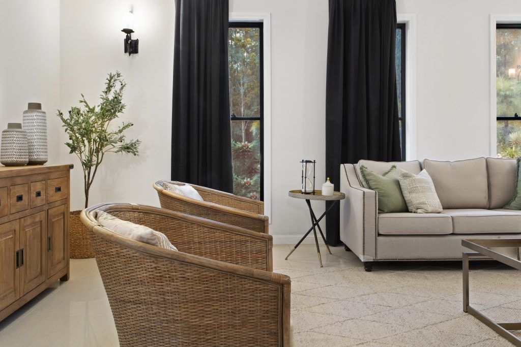 A living room with a couch , chairs , and a table.