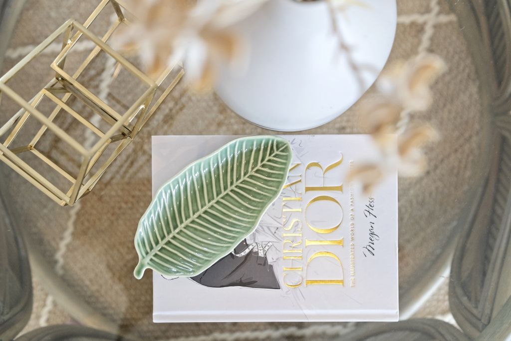 A book titled christian dior is sitting on top of a coffee table.
