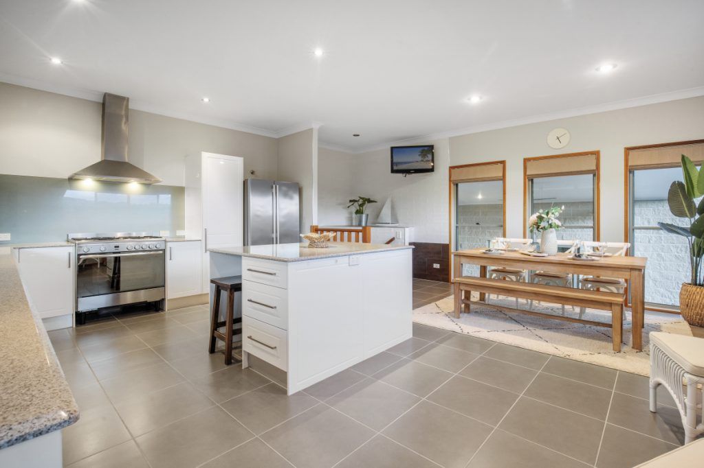 A kitchen with a large island and a dining table.