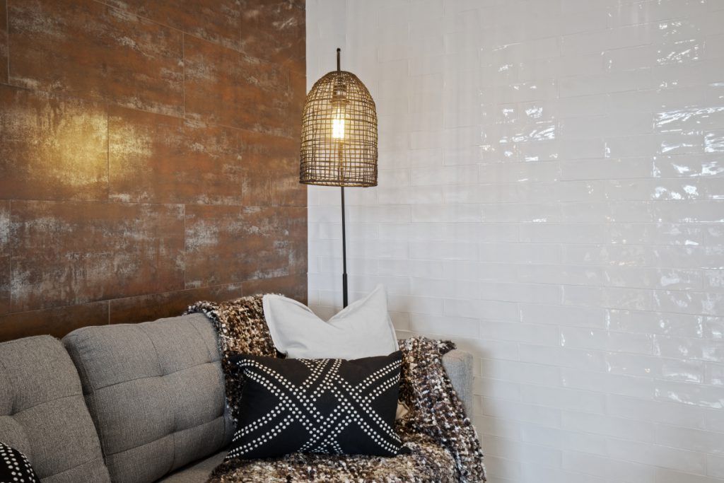 A living room with a couch and a lamp.