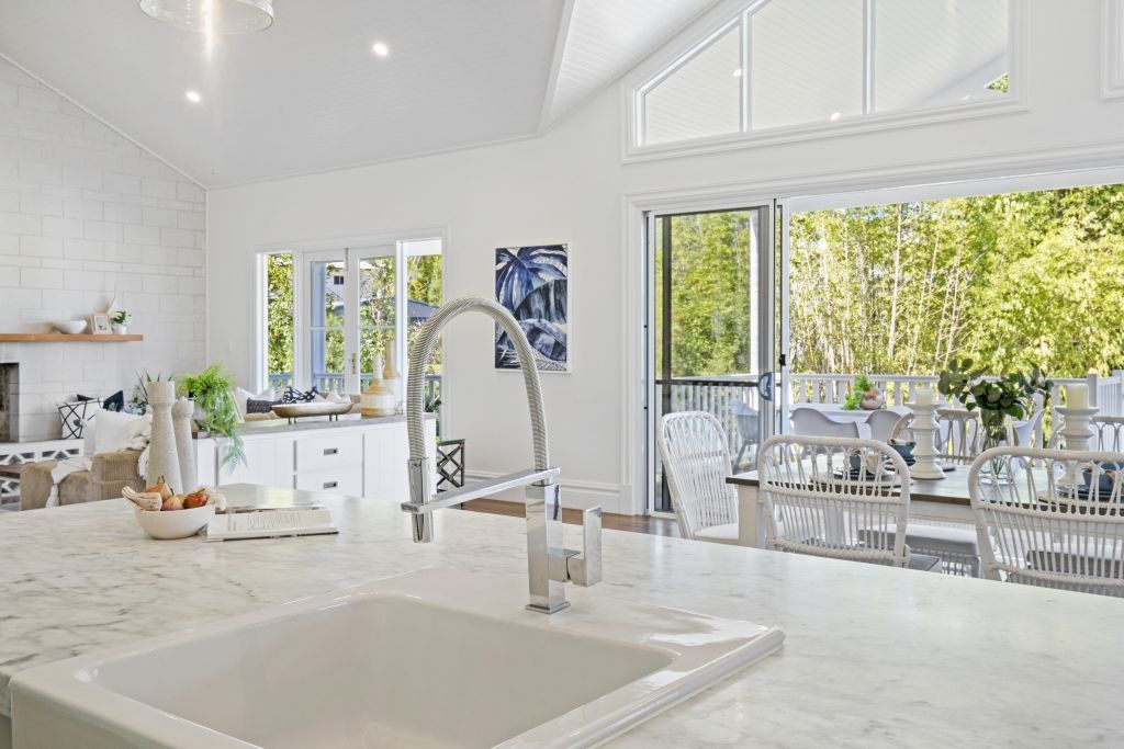 A kitchen with a sink and a large window.