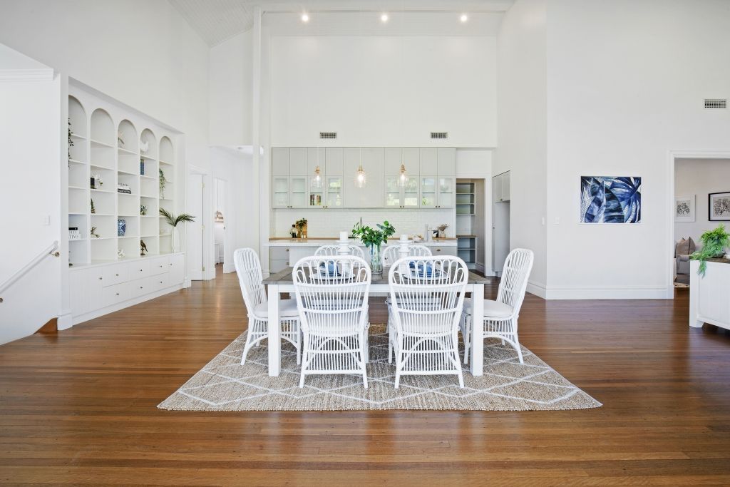 There is a dining table and chairs in the middle of the room.