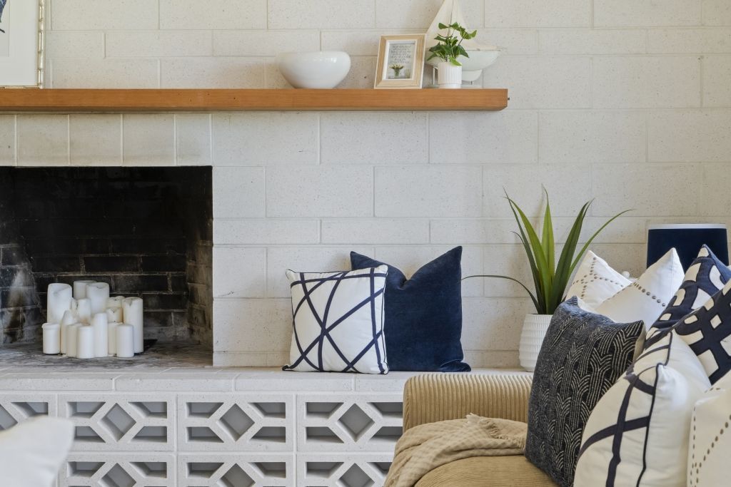 A living room with a fireplace and a couch