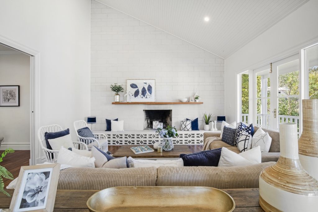 A living room filled with furniture and a fireplace.