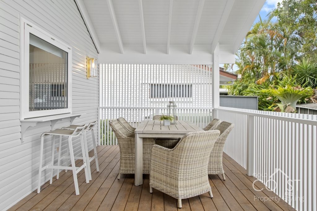 A deck with a table and chairs on it
