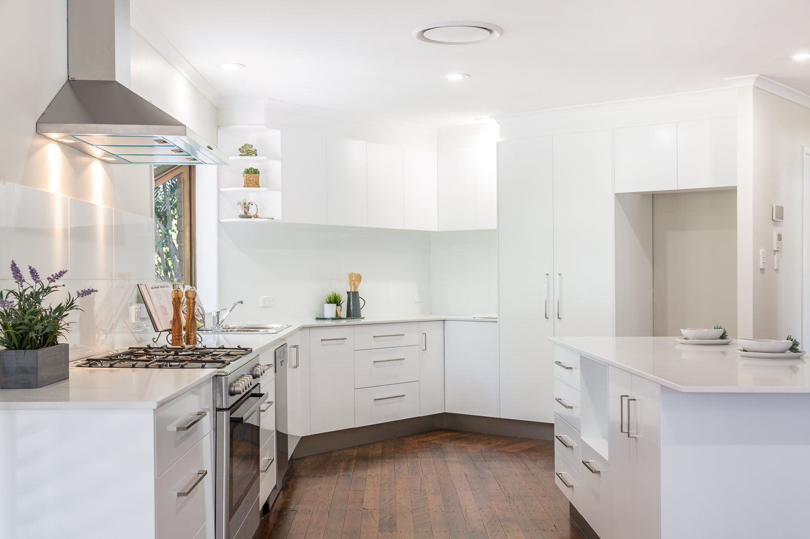 A kitchen with white cabinets and stainless steel appliances.