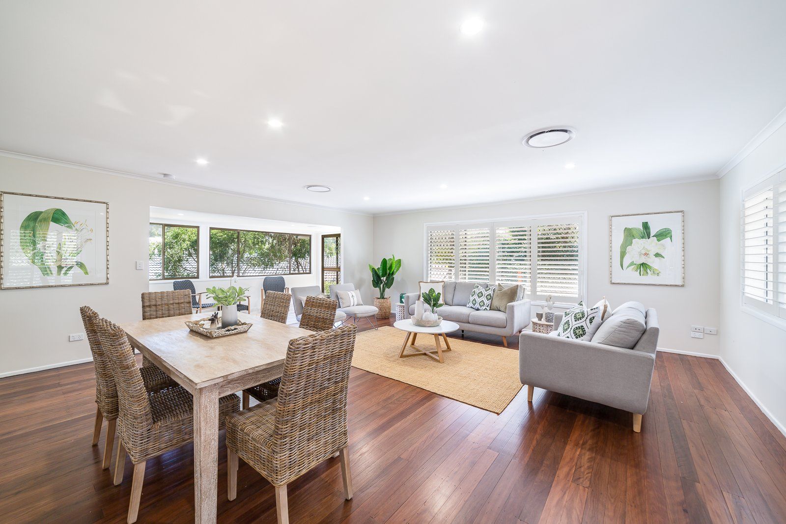 A living room with a dining table and chairs and a couch.