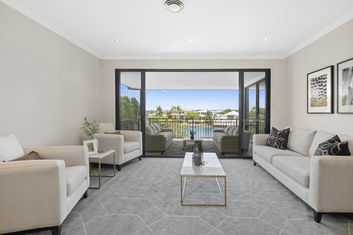 A living room with two couches , two chairs and a coffee table.