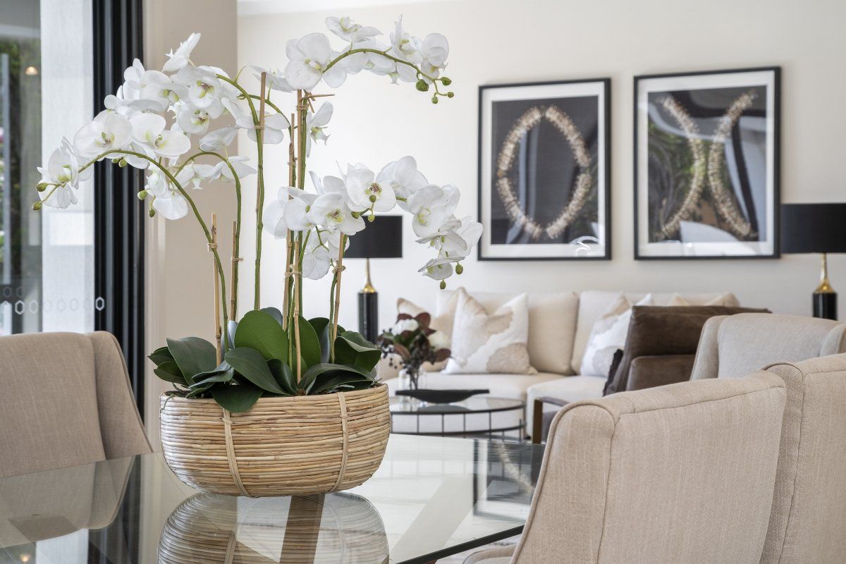 A living room with a vase of flowers on the table