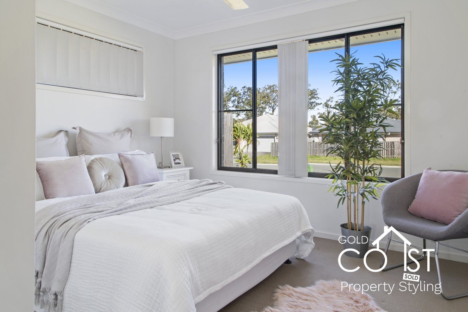 A bedroom with a bed , chair , and window.