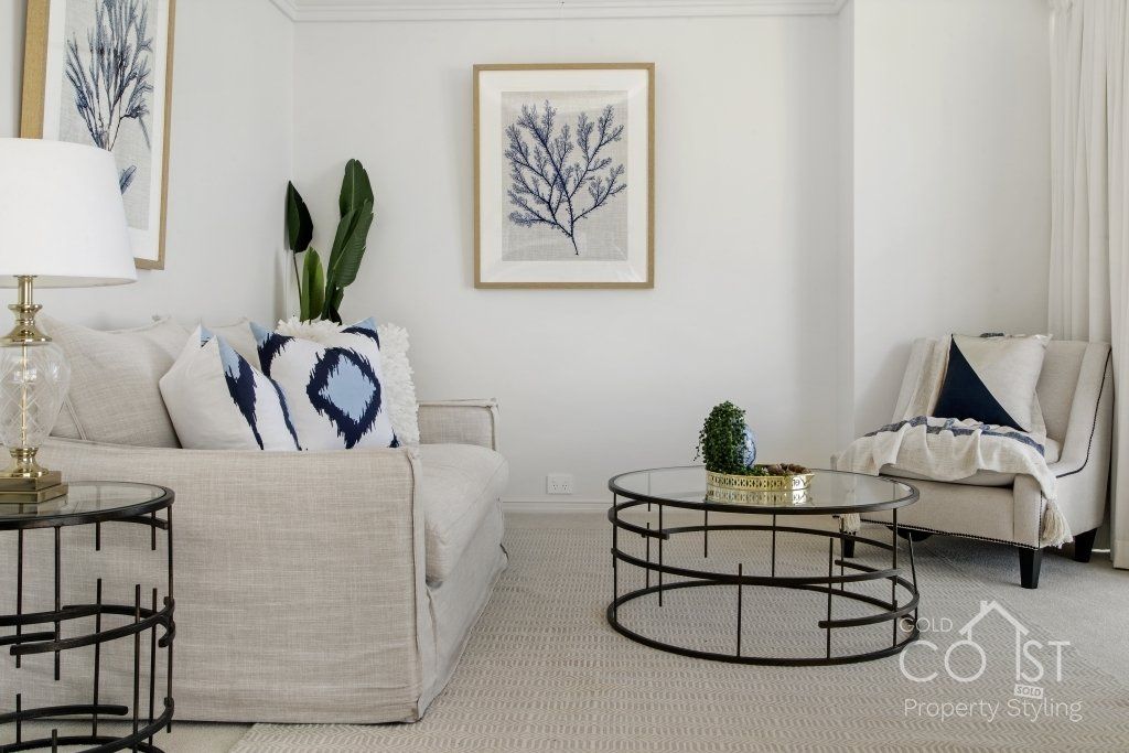 A living room with a couch and two coffee tables