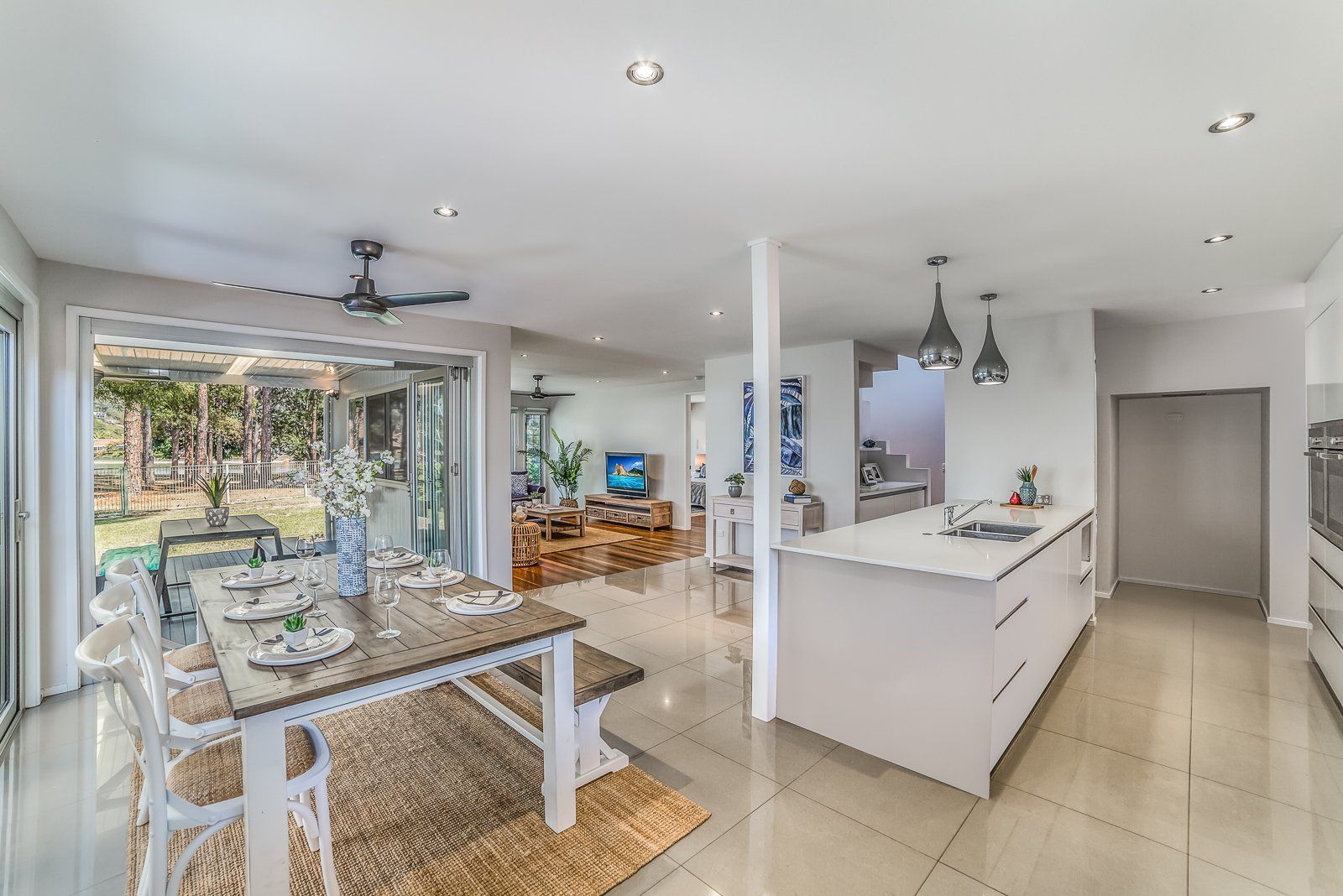 A kitchen and dining room in a house with a table and chairs.