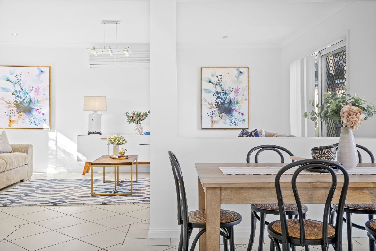 There is a dining table and chairs in the middle of the room.