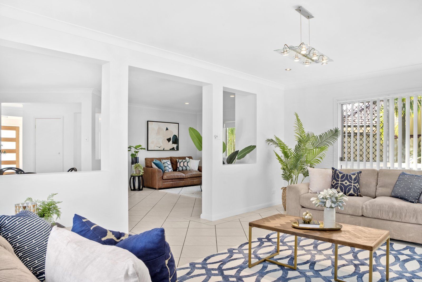 A living room with two couches , a coffee table , and a rug.