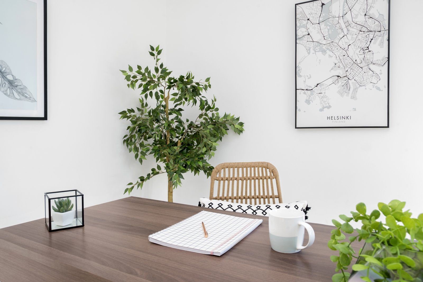 A desk with a notebook and a cup of coffee on it.