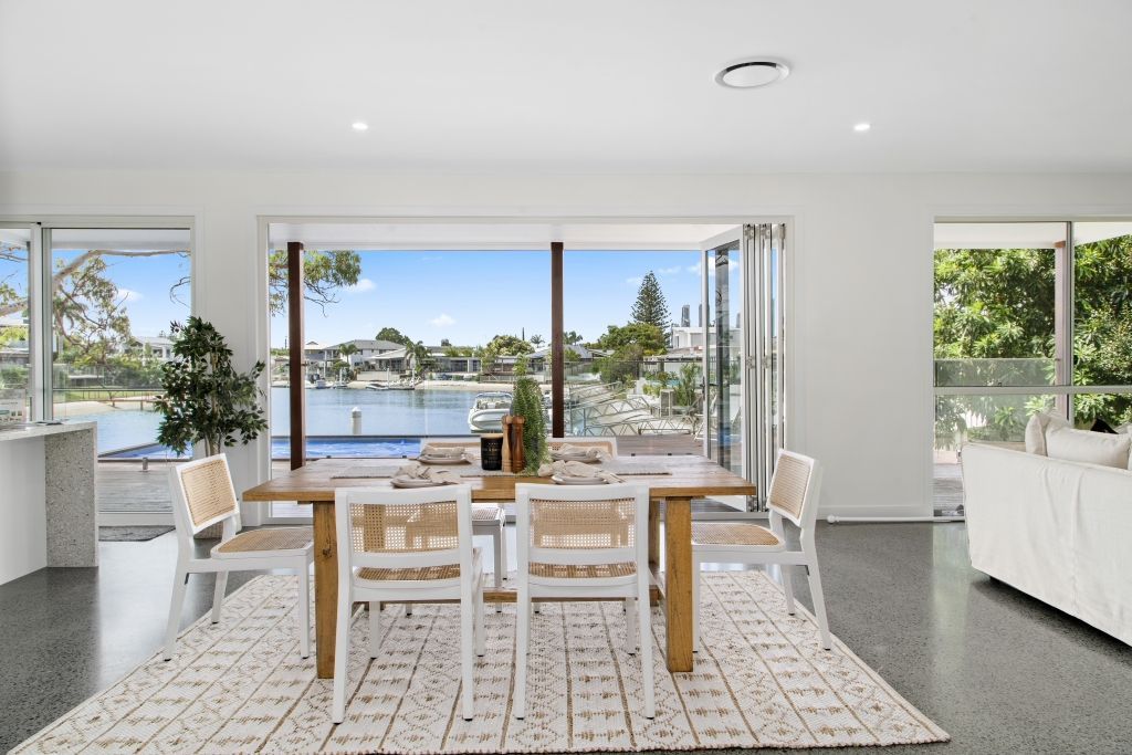 A dining room with a table and chairs and a rug