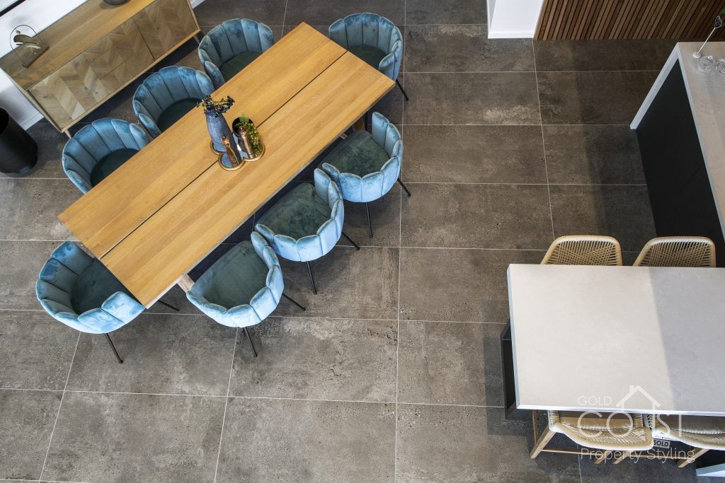 An aerial view of a dining room with a table and chairs