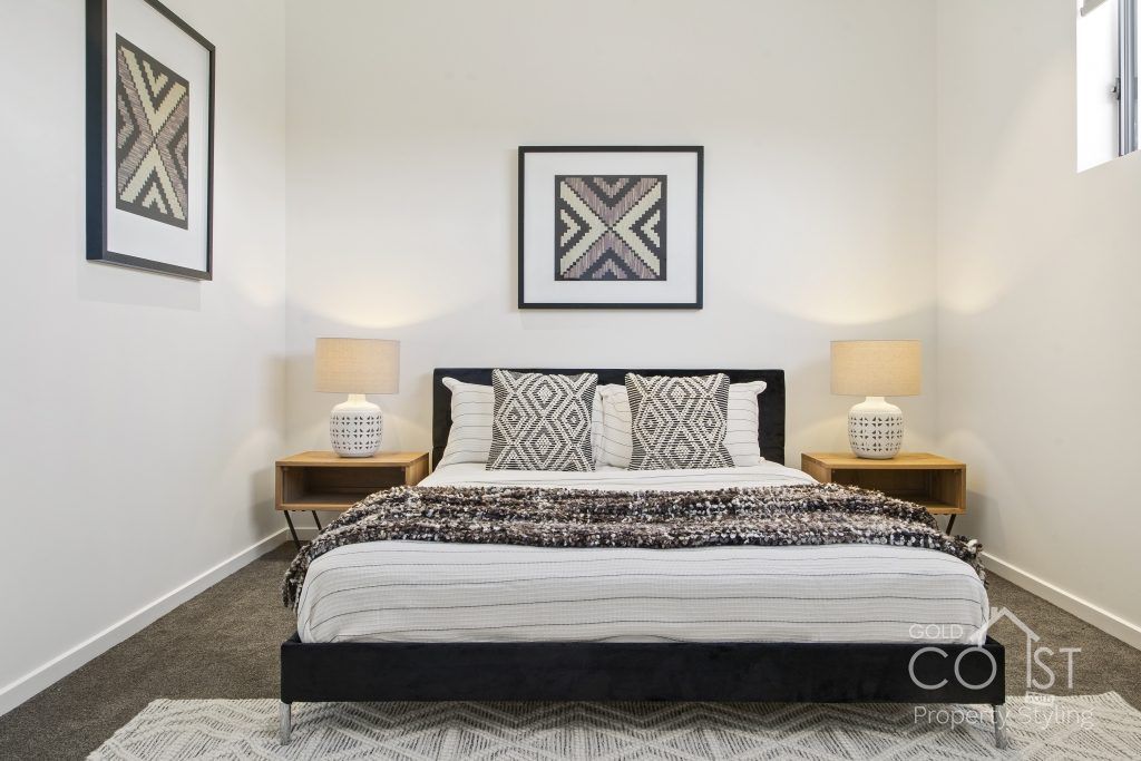 A bedroom with a large bed and two nightstands