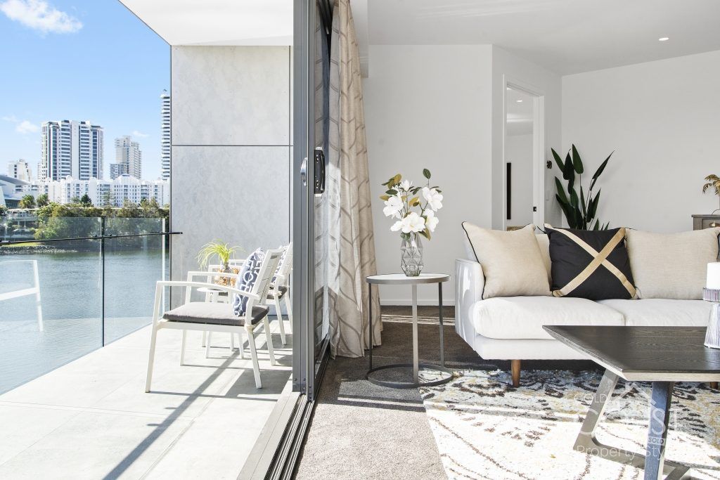 A living room with a couch and a view of a lake