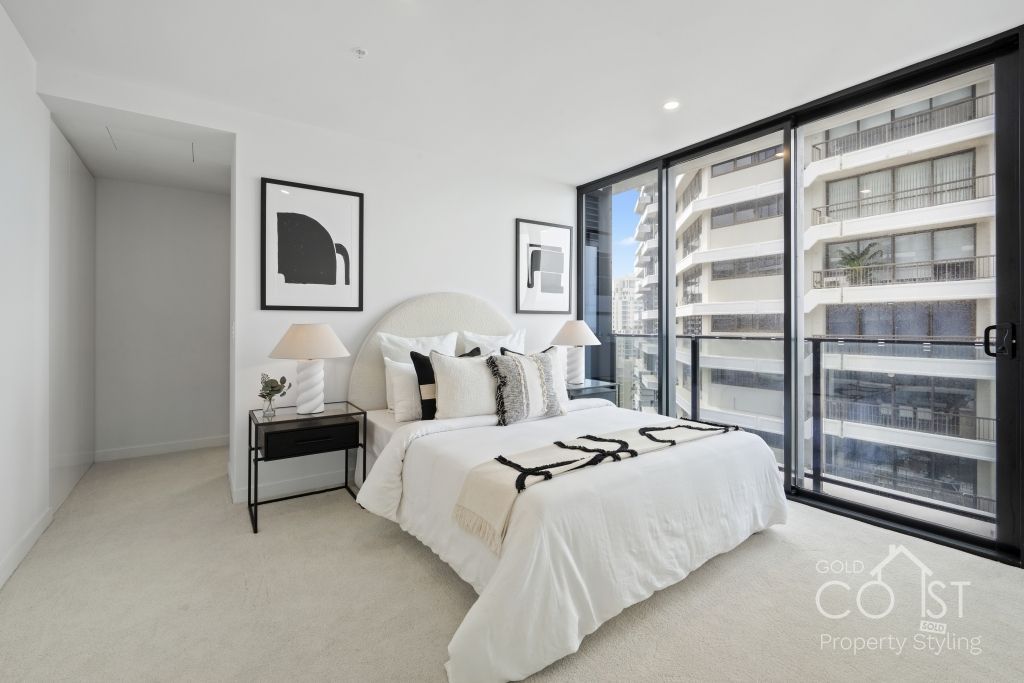 A bedroom with a large bed and sliding glass doors