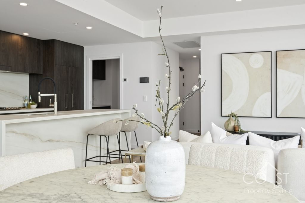 There is a vase of flowers on the table in the living room.