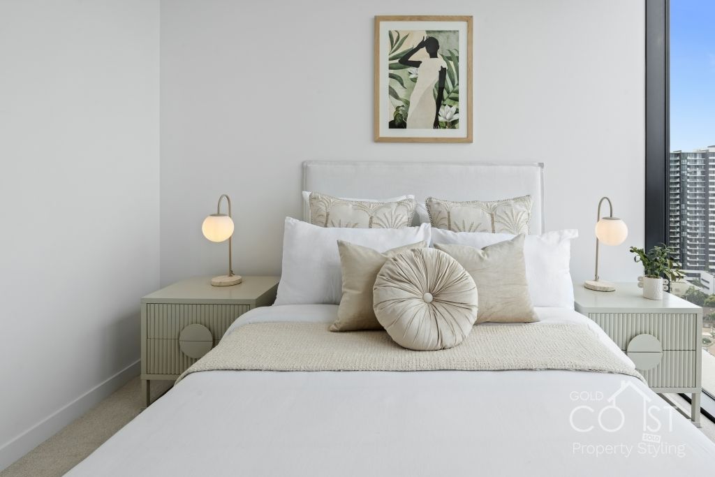 A bedroom with a bed and a picture on the wall