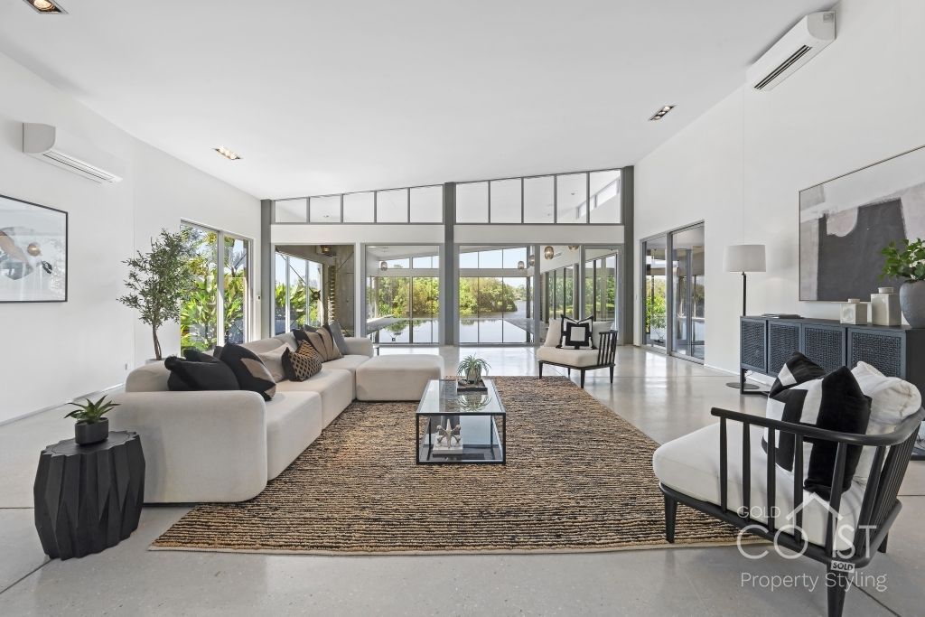A living room with a couch , chair , table and rug.