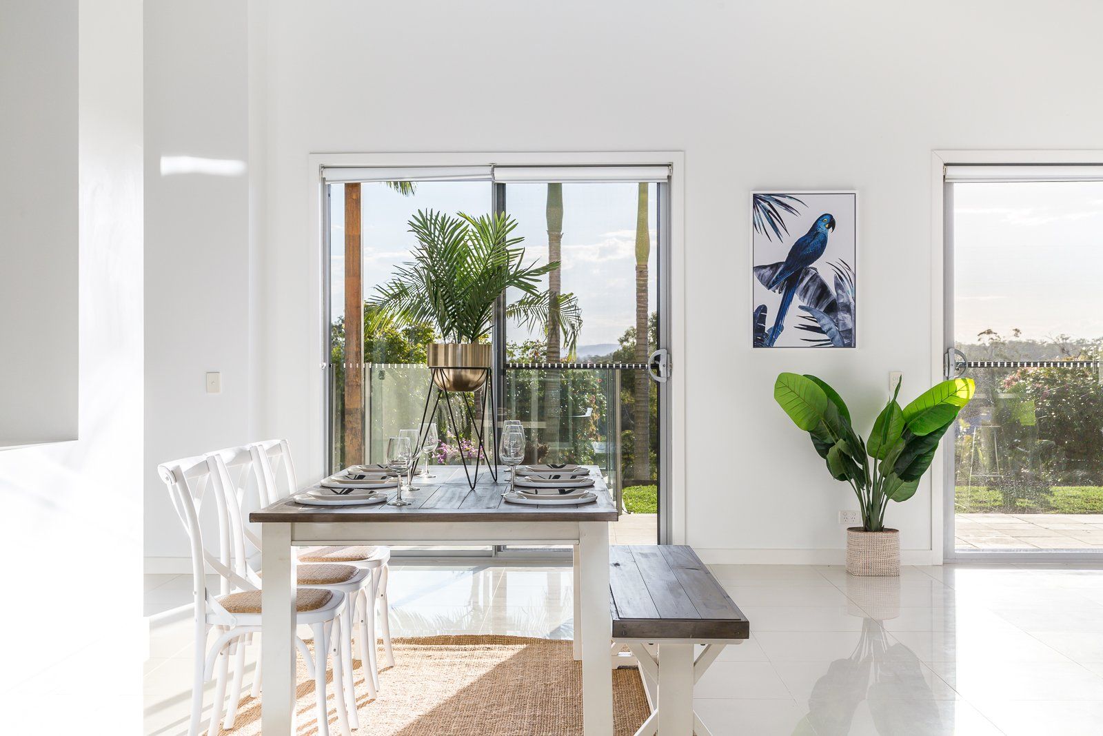 A dining room with a table and chairs and a bench.