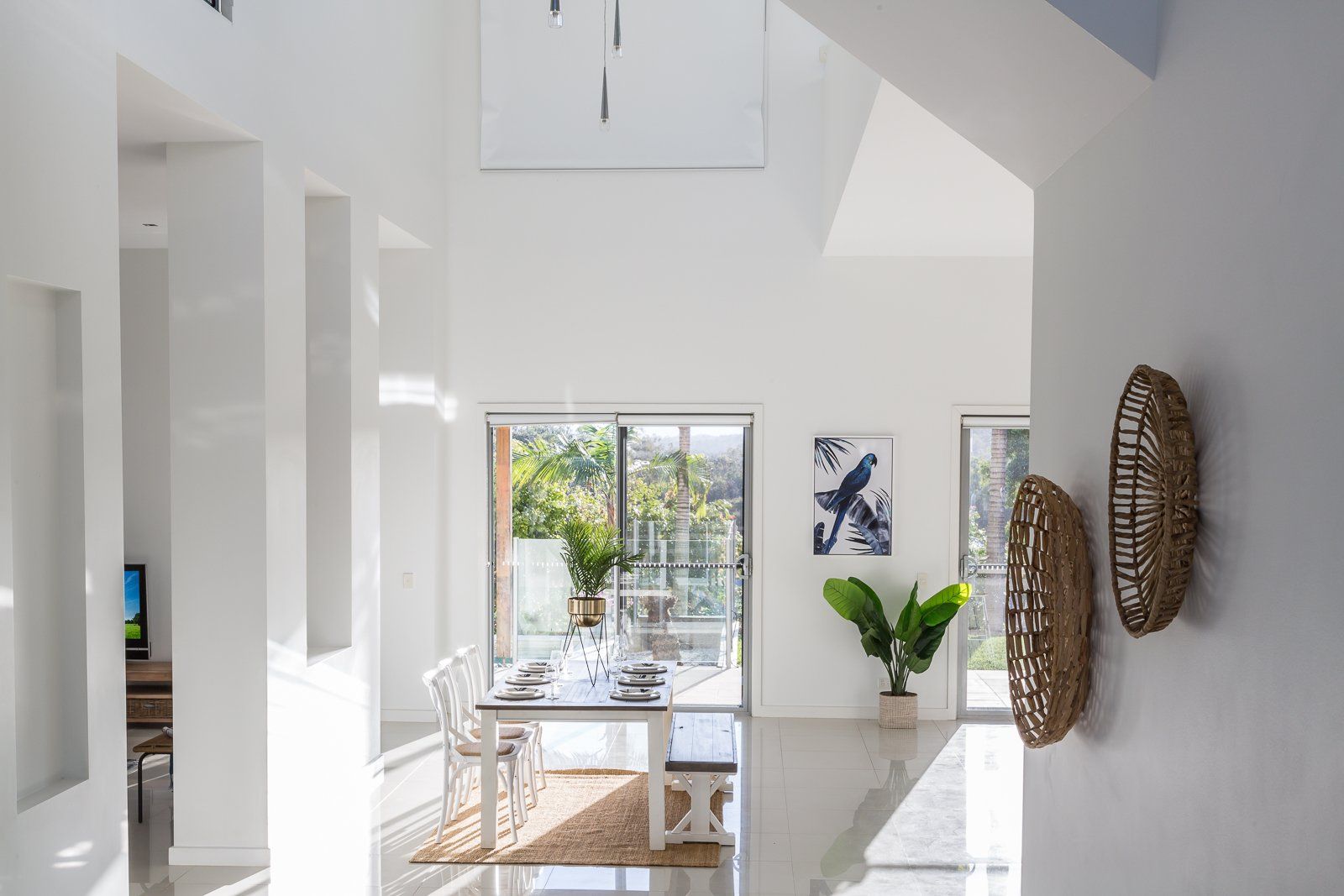 A living room with a table and chairs and a sliding glass door.