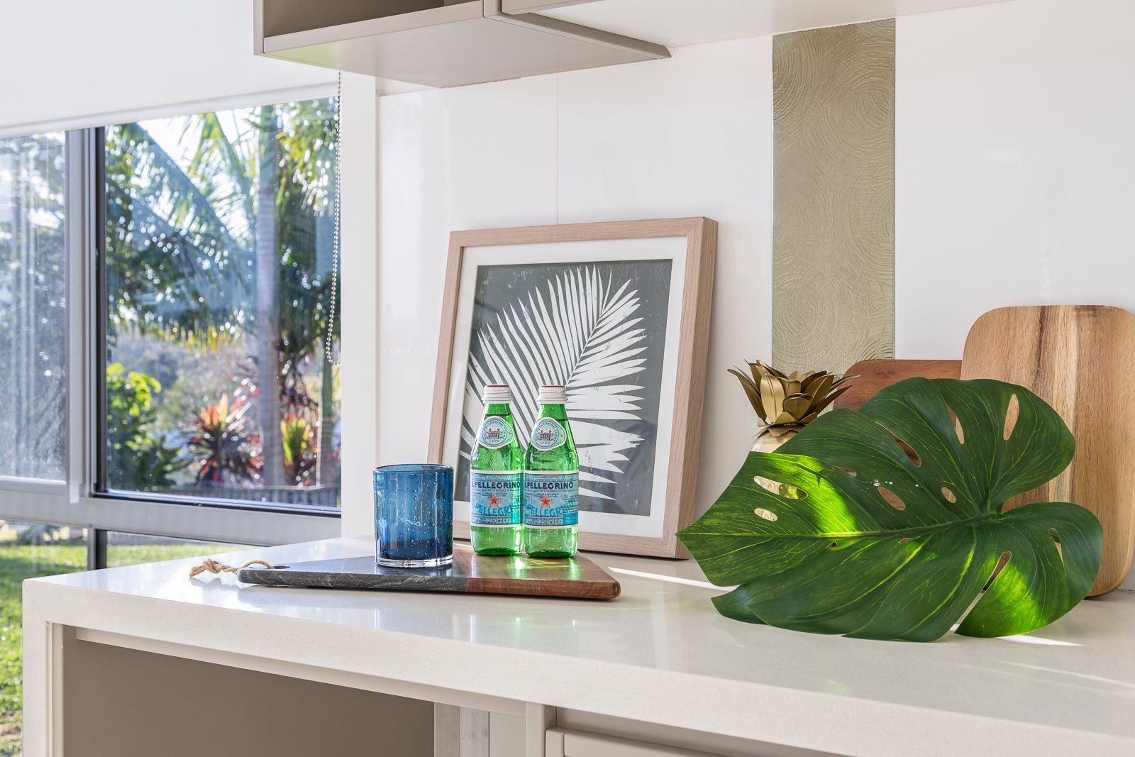 A kitchen counter with a picture of a palm tree on it.