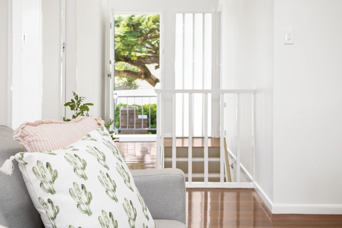 A living room with a couch and a pillow on it.