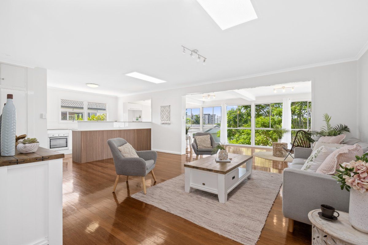 A living room with a couch , chairs , and a coffee table.