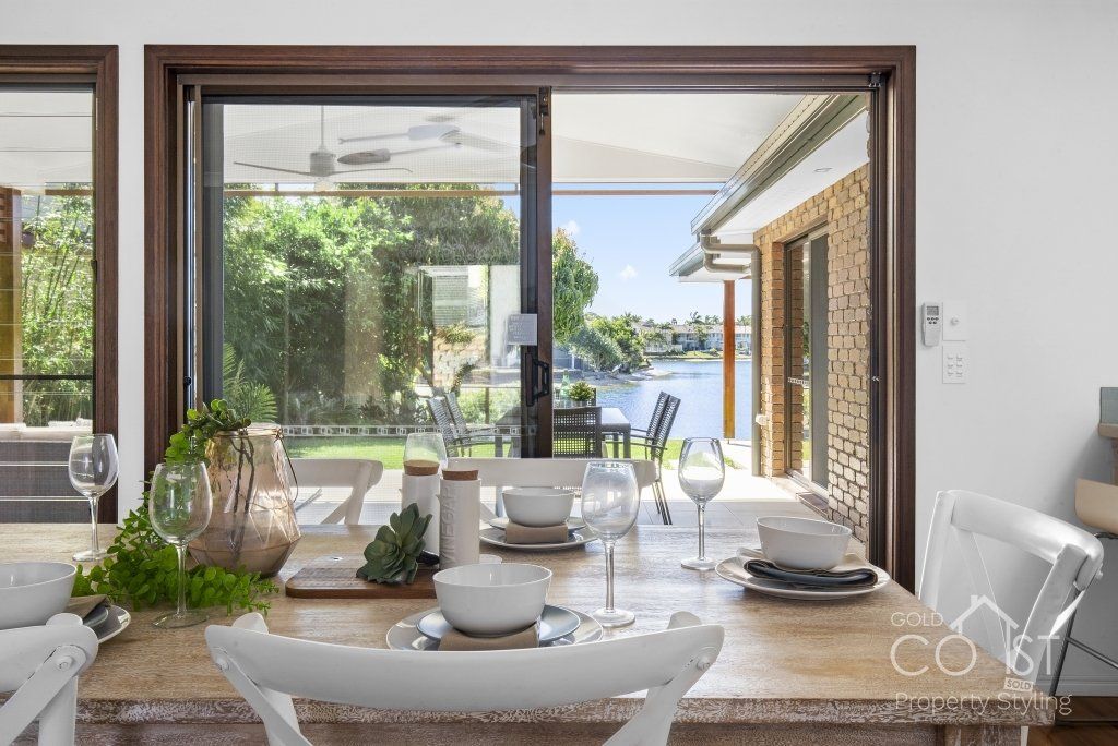 A dining room with a table and chairs and a sliding glass door leading to a patio.