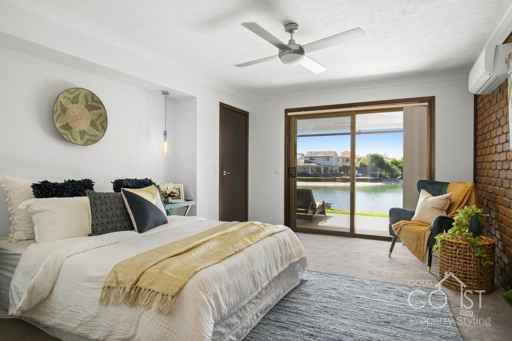 A bedroom with a large bed and a ceiling fan.
