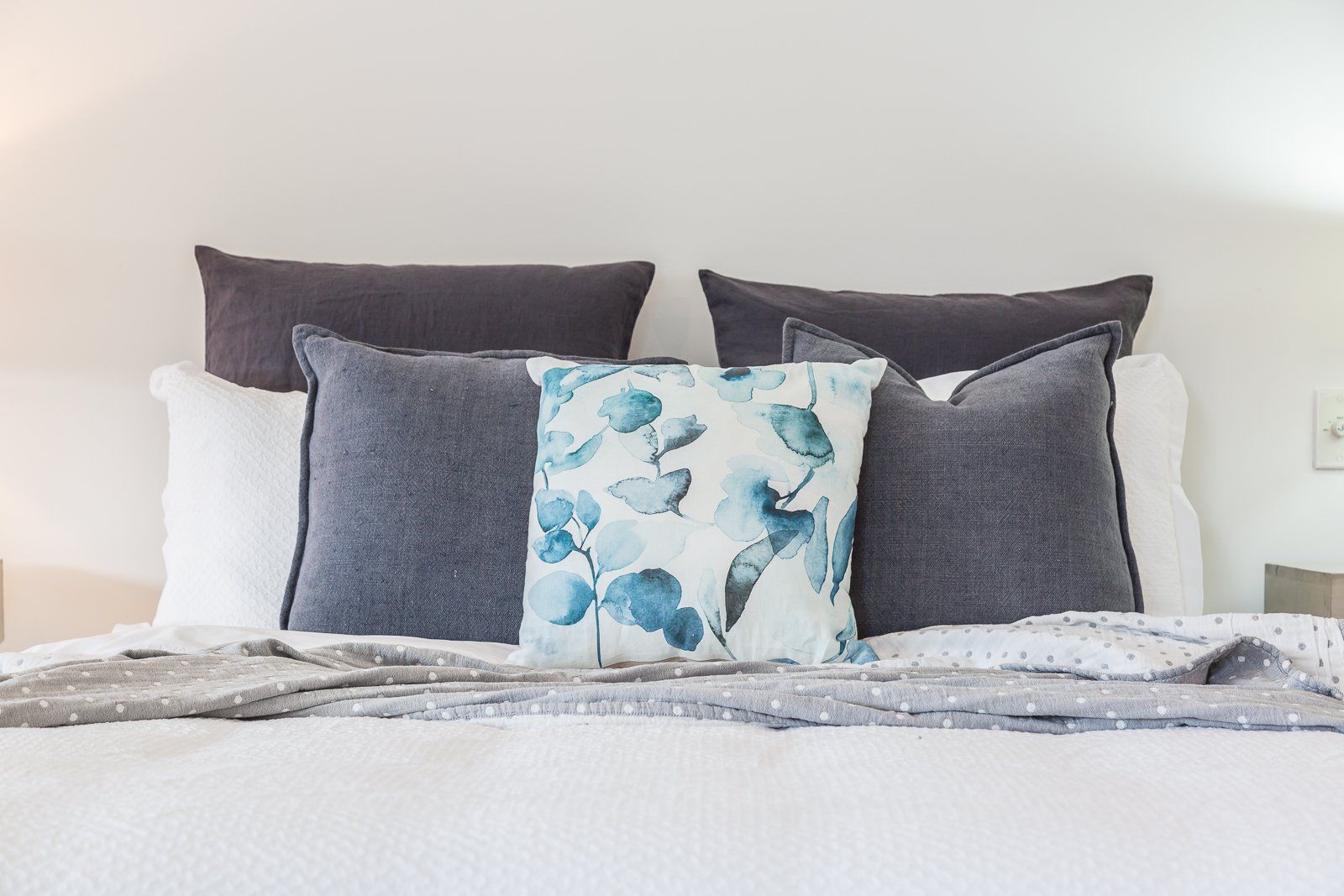 A bed with a lot of pillows on it