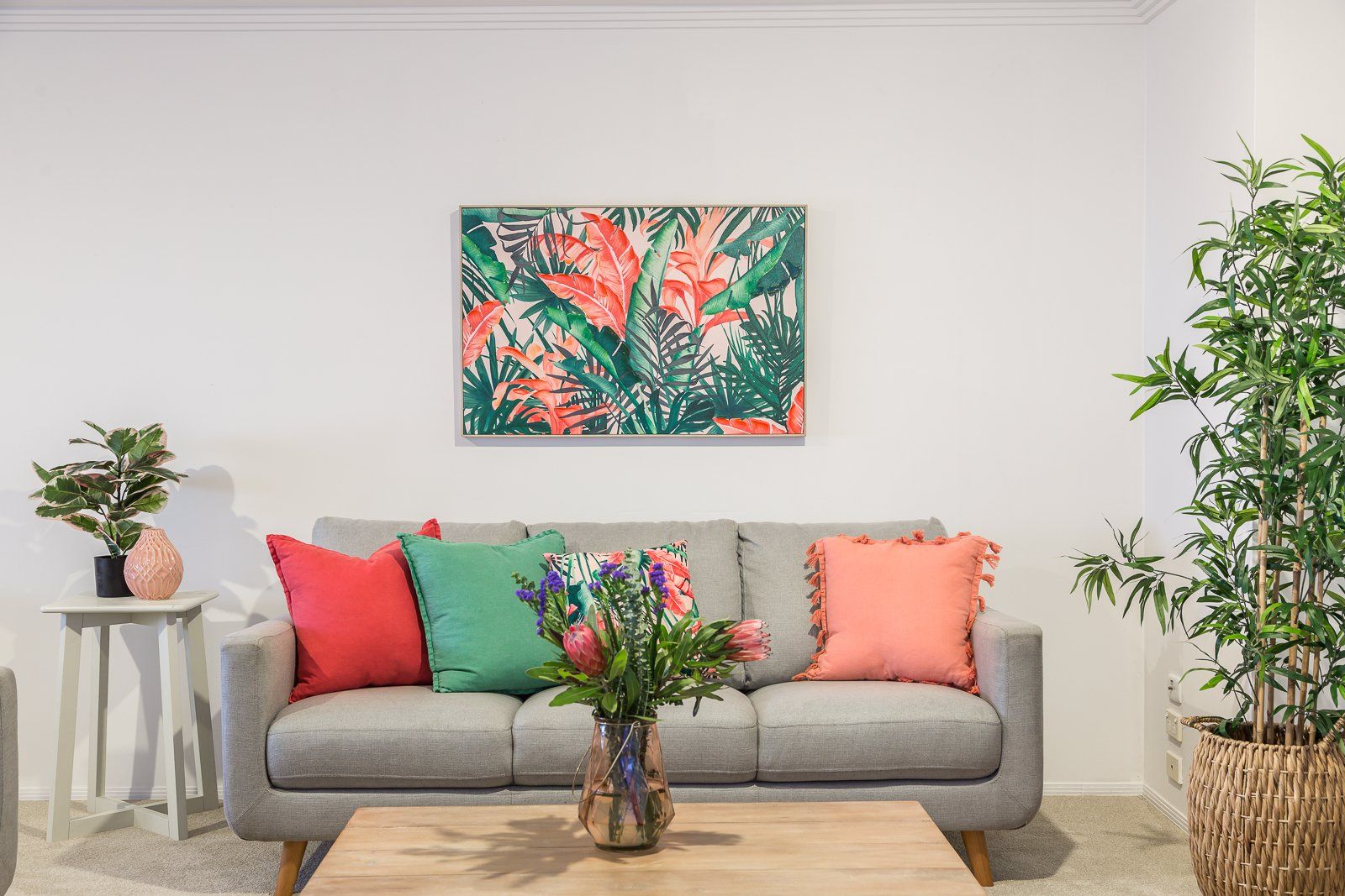 There is a painting on the wall above the couch in the living room.