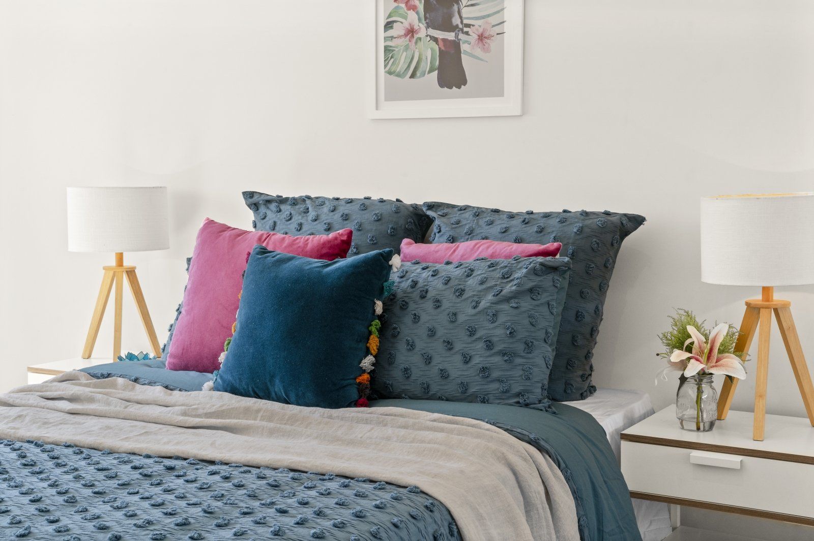 A bed with a blanket and pillows on it in a bedroom.