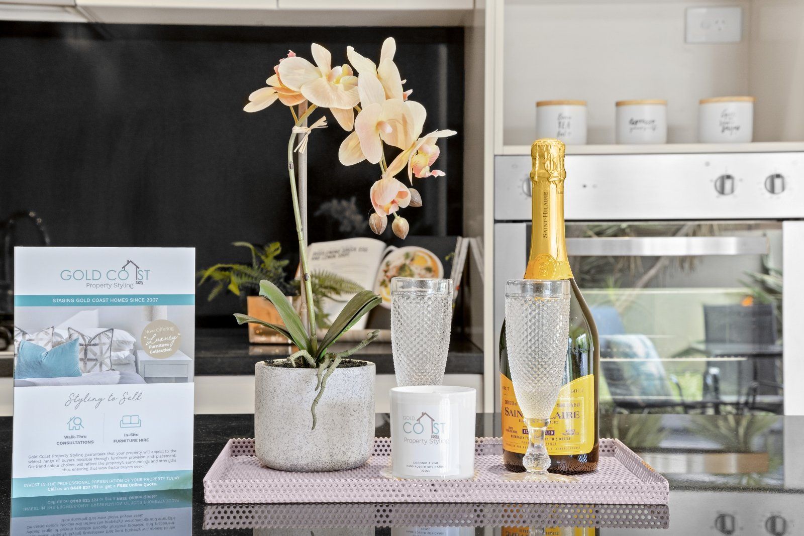 There is a bottle of champagne on a tray in the kitchen.