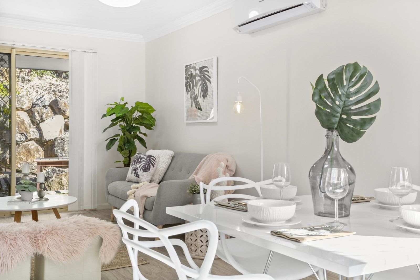 A living room with a dining table and chairs and a couch.