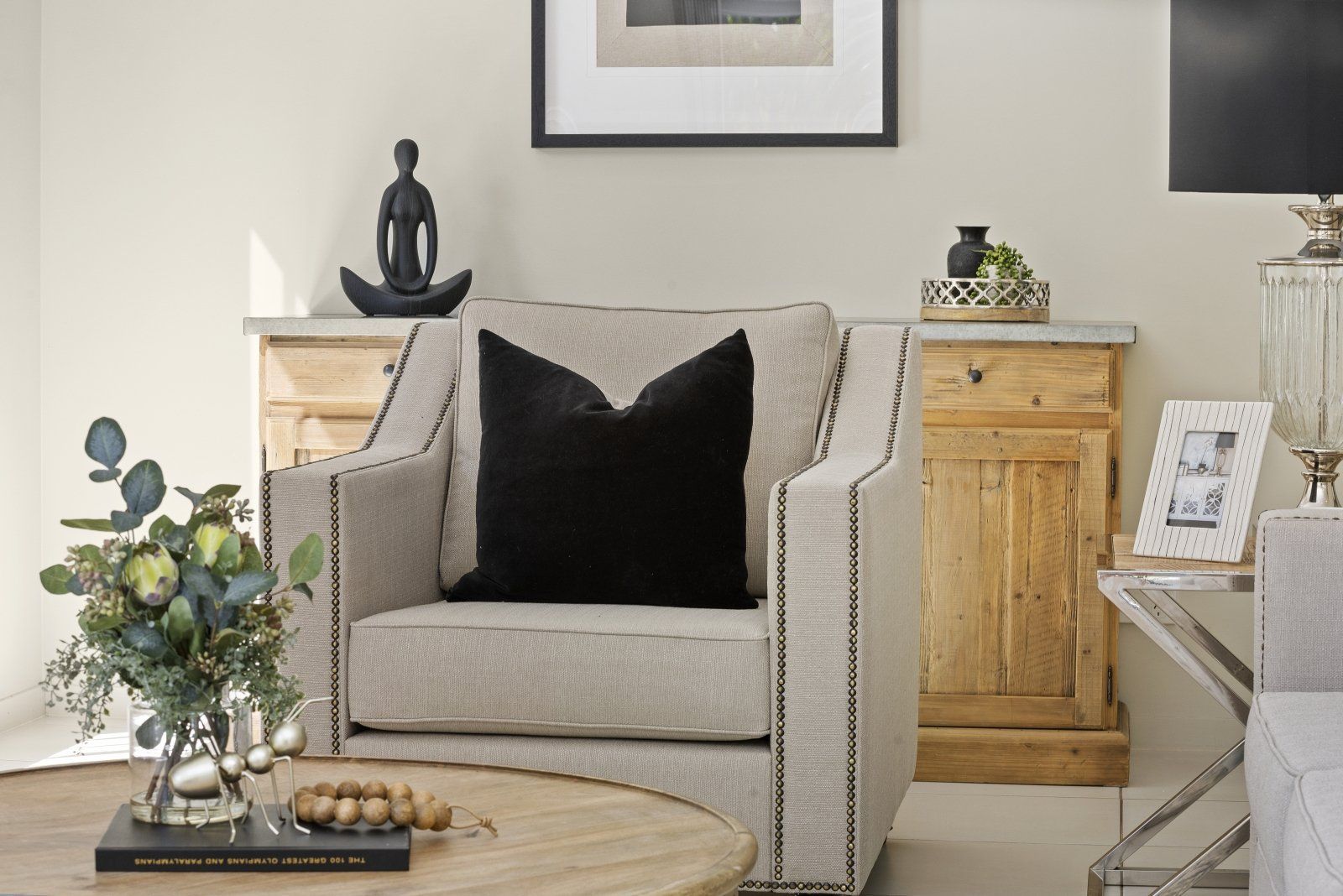 A living room with a chair and a coffee table