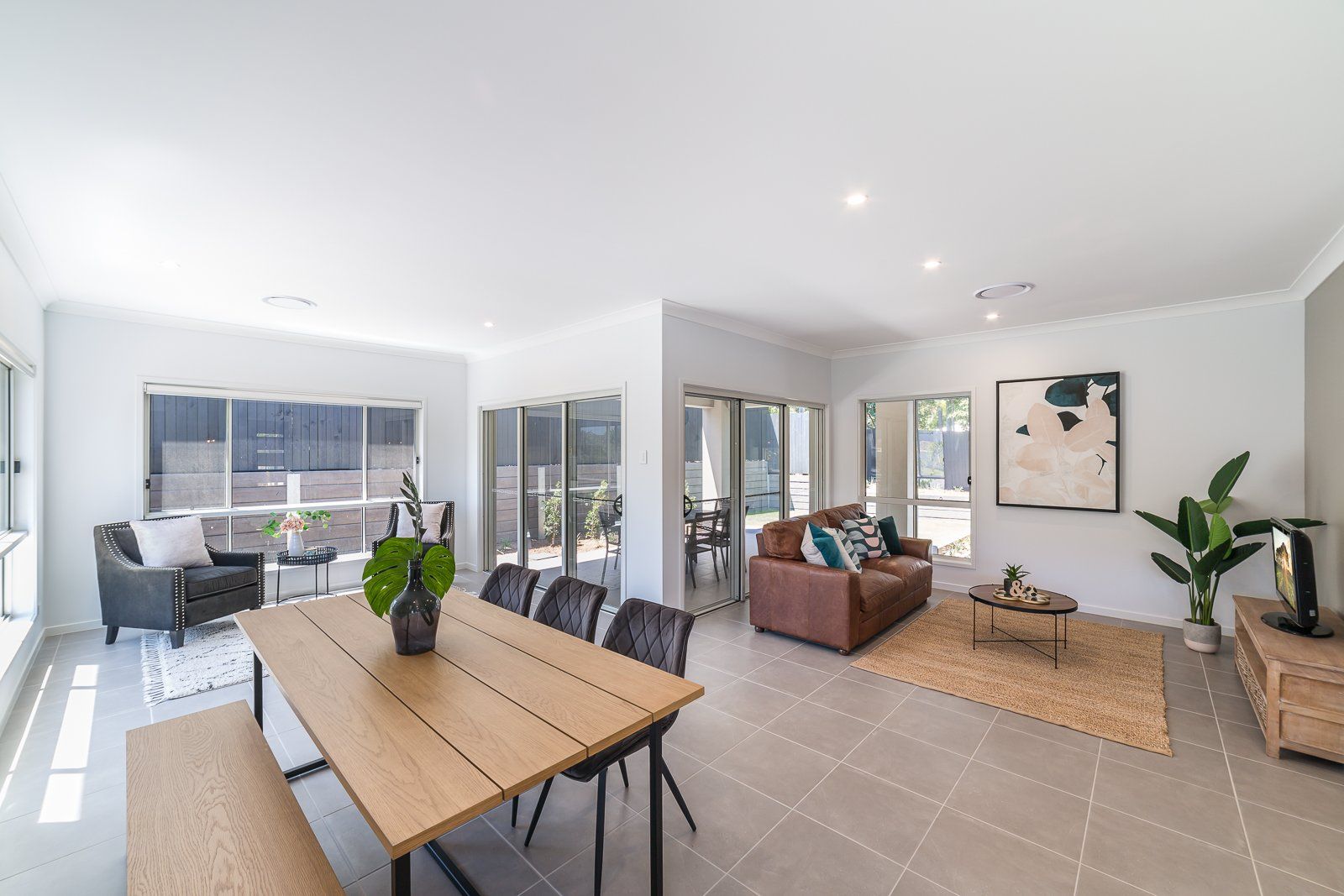 A living room with a dining table and chairs and a couch.